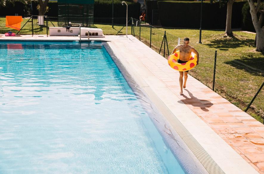a man jumping into pool