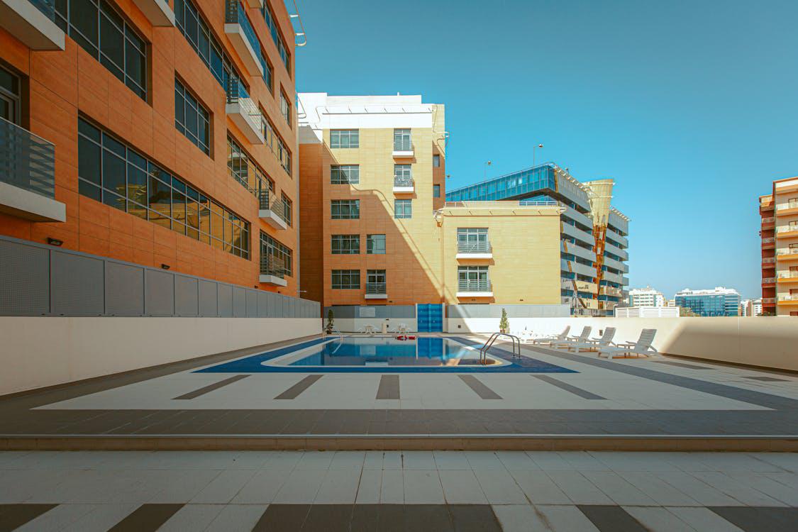 A newly remodeled commercial pool in Pasadena featuring custom coping, waterline tiles, and eco-friendly design elements.