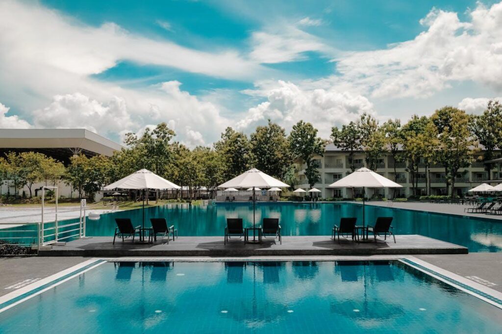 Two luxury swimming pools side by side at a hotel