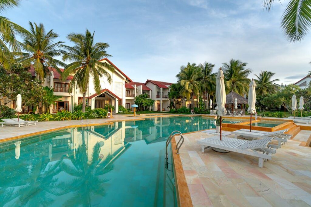 A resort swimming pool with sun loungers