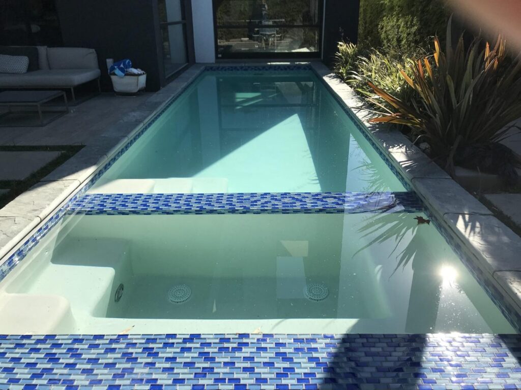 A compact pool design in an urban Los Angeles backyard.