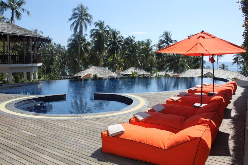 A modern swimming pool with orange lounges