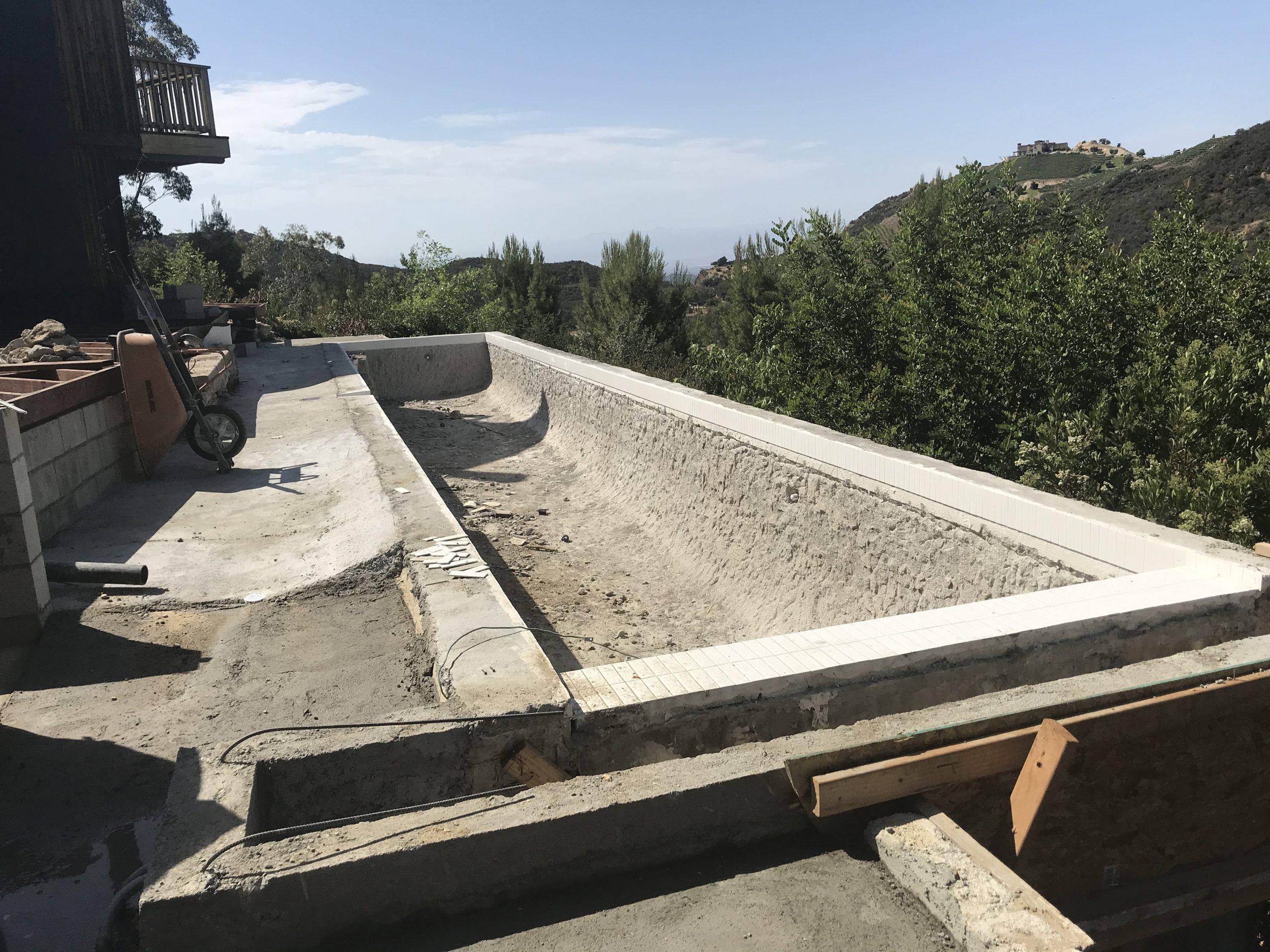 A team of professionals working on a pool resurfacing project