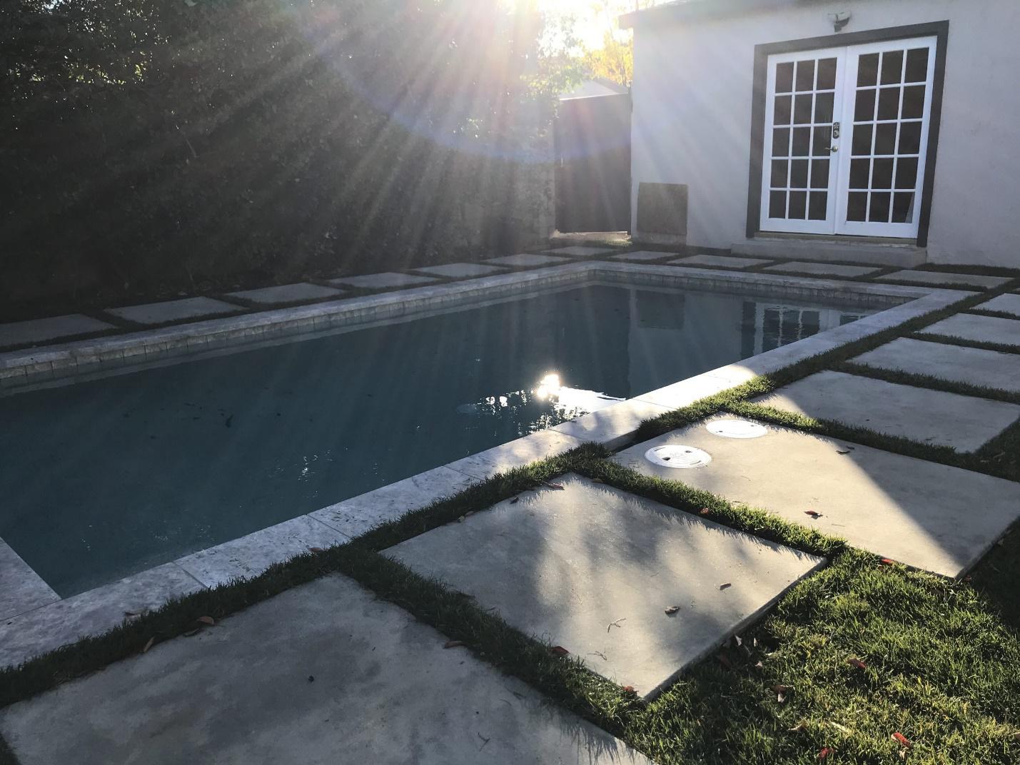 A newly remodeled commercial pool in Pasadena featuring custom coping, waterline tiles, and eco-friendly design elements.