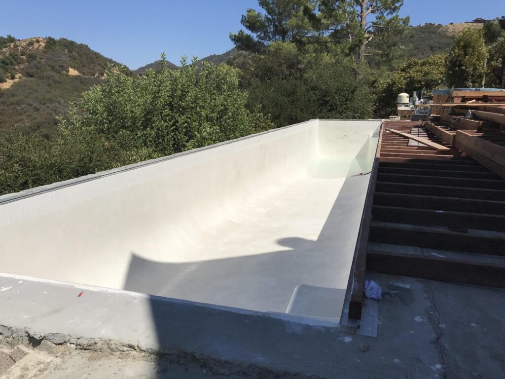 City-approved materials like white plaster and fiberglass used in a pool remodel.