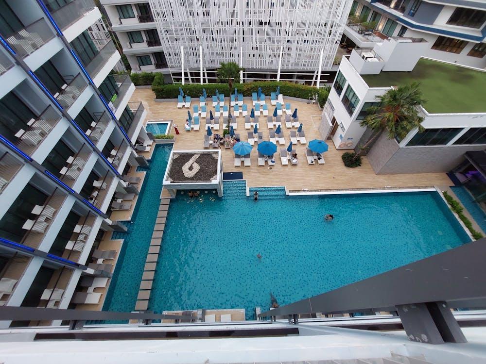 People sitting near a newly renovated pool in a resort