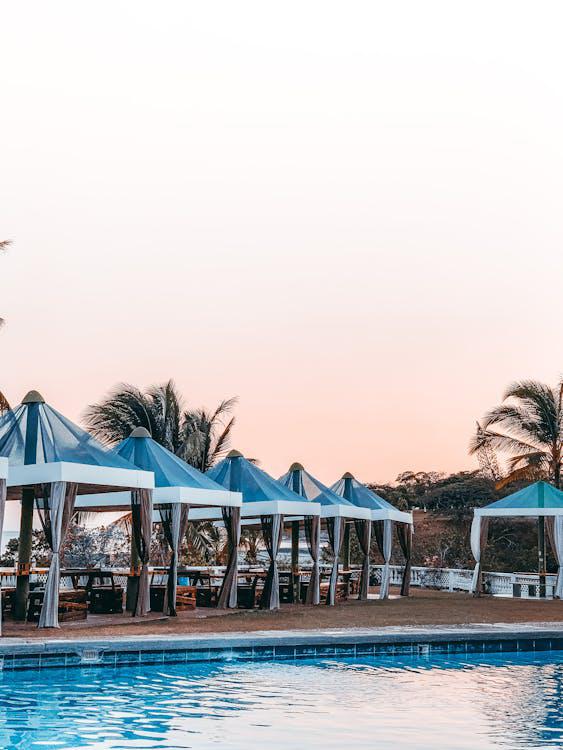 A swimming pool with gazebos around